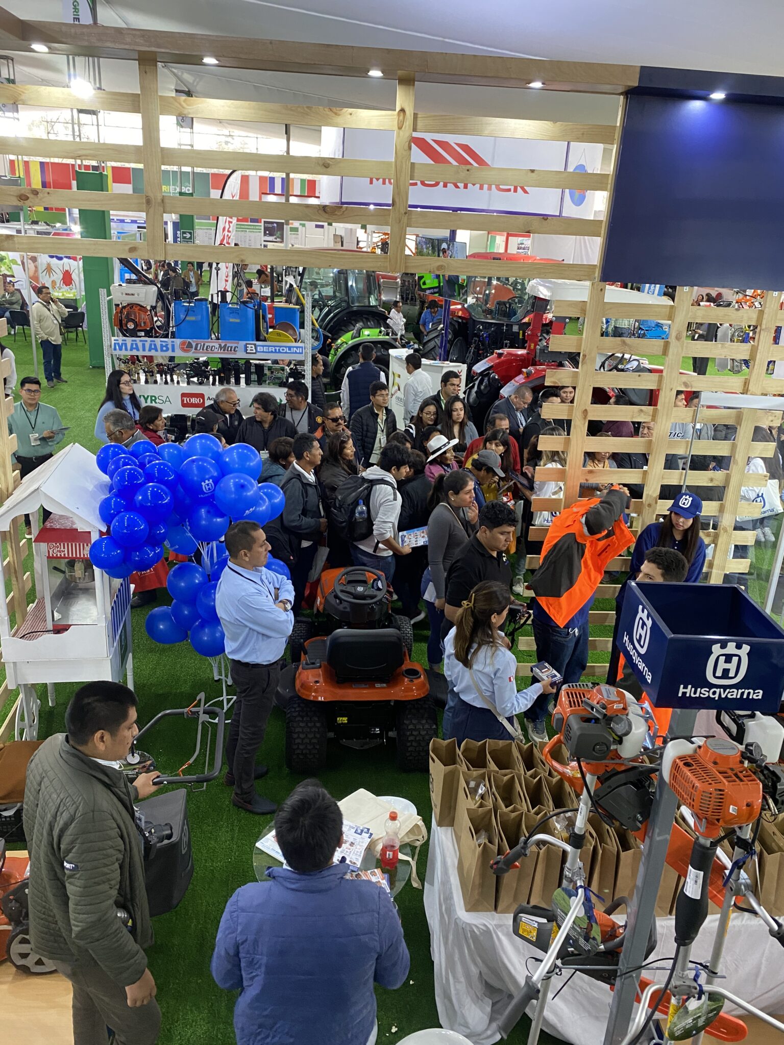 Visitantes observando maquinaria Husqvarna en el stand de AGRIEXPO 2025